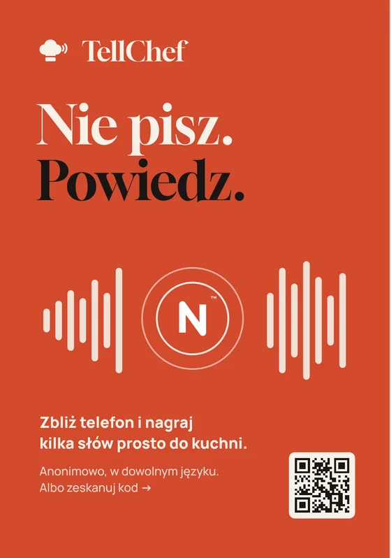 Paprykowy stojak z napisem Nie pisz. Powiedz. i falą dźwięku